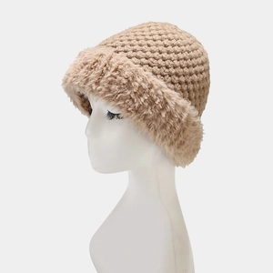 Close-up of khaki knit winter hat with thick faux fur trim and warm woven texture