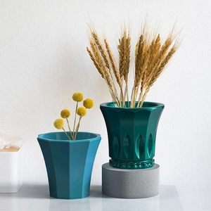 Detailed view of geometric blue and emerald green textured resin planter molds for DIY resin art
