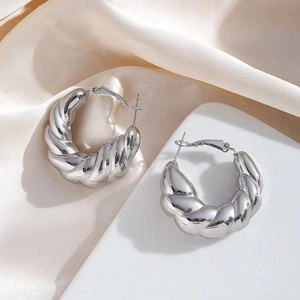 Modern twisted croissant stud earrings in polished silver stainless steel finish