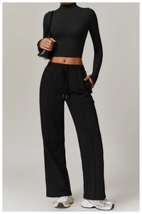 Detail of high-waisted wide-leg sweatpants with drawstring and cropped long sleeve top