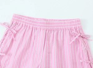 Detail of pink and white striped poplin shorts with elastic waist and side bow accents