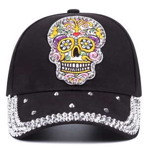 Fashionable baseball cap with sugar skull embroidery and rhinestone studded brim in black
