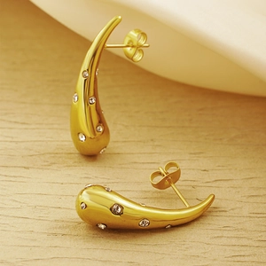 Detail of gold teardrop earrings with crystals and secure butterfly back closure