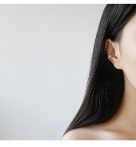 Detailed view of 925 sterling silver triple-layered ear cuff on a female model