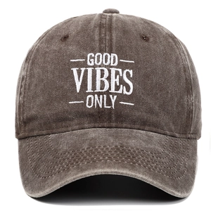 Detail of embroidered 'GOOD VIBES ONLY' slogan on distressed brown cotton baseball cap