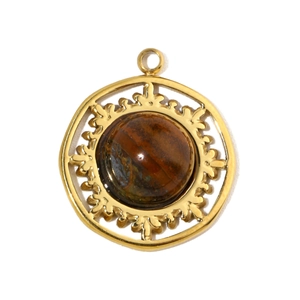 Detailed macro view of a vintage round gold pendant featuring a natural tiger eye stone