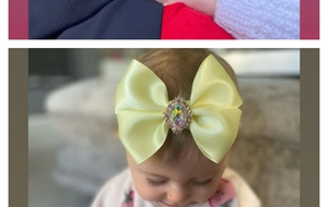 Detail of yellow satin bow headband for babies with a vintage iridescent gemstone center