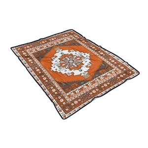 Detailed view of orange and brown flannel blanket with white geometric star medallion patterns