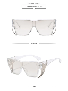 Detail of square transparent sunglasses featuring silver flame-shaped metal side accents