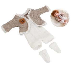 Detailed view of beige knitted doll cardigan, lace romper and socks set for 30cm baby dolls