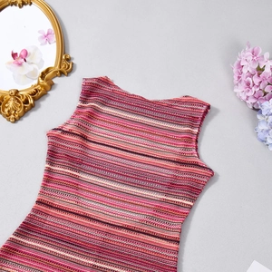 Flat lay detail of a striped knit sleeveless romper with colorful crochet textures
