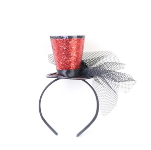 Detail of red sequined mini top hat headband with black lace net and veil decoration