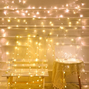 Star and ball LED string lights with warm yellow glow for indoor room decoration