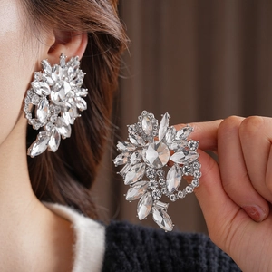 Macro view of crystal cluster heart earrings with silver finish and marquise cut zircons