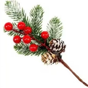 Detail of Christmas artificial pine branch with red berries, pine cones and snow decor