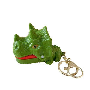 Green triceratops dinosaur biting finger toy keychain with movable jaw and gold ring