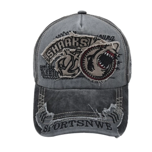 Detail view of embroidered shark patch and distressed vintage grey baseball cap texture