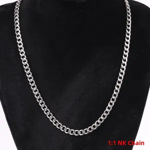 Detailed close-up of a silver stainless steel NK curb chain on a black velvet display
