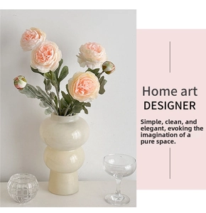 Pink artificial peony flowers in a minimalist double sphere cream ceramic vase for home decor
