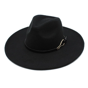 Close-up of black wool fedora featuring a gold metal buckle on a sleek leather band
