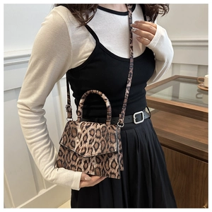 Detail of leopard print crossbody bag with metal buckle and adjustable strap