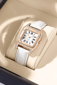 Close-up of square rose gold watch with crystal bezel and white Roman numeral dial