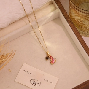 Golden necklace featuring pink enamel butterfly pendant and bead in French vintage style