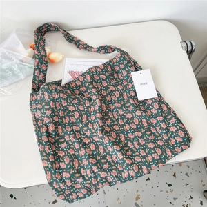 Detail of vintage floral corduroy tote bag with soft inner texture and brand tag