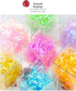 Close-up of assorted iridescent shredded raffia paper in transparent storage boxes