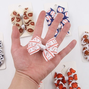 Detail of sports themed bow hair clips with baseball basketball and soccer prints