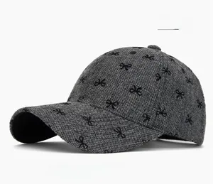 Macro shot of gray wool blend baseball cap with black bow print and textured fabric