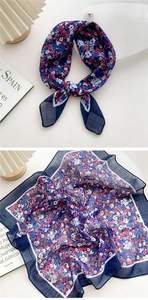 Detail of navy floral cotton linen scarf with rolled edges and lightweight texture
