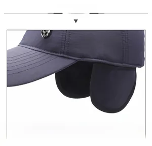 Detailed view of the winter baseball cap featuring ear flaps and metal shield emblem