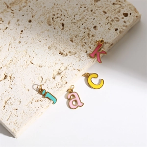 Colorful enamel letter pendants in 18K gold plated stainless steel on a stone base