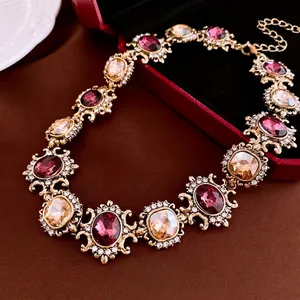 Vintage Baroque style necklace featuring deep red and amber gemstones in a gold finish