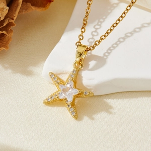 Detail of gold starfish pendant necklace with a star-cut zircon and micro-pave setting