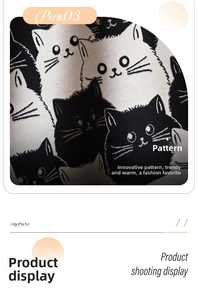 Detailed close-up of cute black and white cat pattern on a thick knit winter shawl