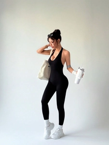 Sleek black backless halter neck seamless yoga jumpsuit with slim fit athletic styling