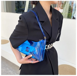 Modern transparent bright blue PVC shoulder bag styled with a minimalist black blazer