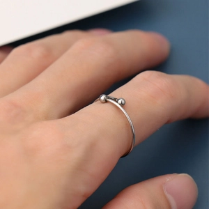 Minimalist silver stainless steel open ring with dual bead accents on hand