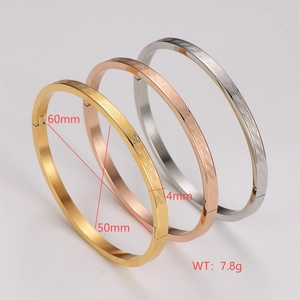 Three-piece spiral textured bangles in gold, rose gold, and silver stainless steel