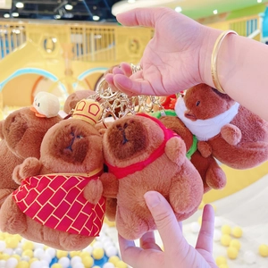 Close-up of five cute Capybara plush keychains with various outfits and golden clips