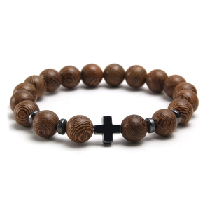 Natural wood bead bracelet with a black cross and steel accents on a white background