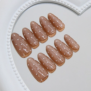Vintage caramel cat-eye press-on nails with white polka dots in almond shape