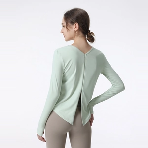 Women's loose long sleeve yoga top in mint green with open back and split hem detail