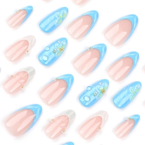 Blue and nude press-on nails with 3D water drops, floral patterns, and pearls