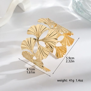 Macro view of gold ginkgo leaf cuff bracelet with product dimensions and weight