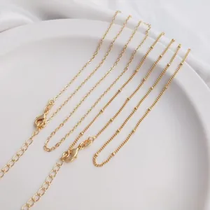 Close-up of 14K gold plated necklace chains with lobster clasp and extension links