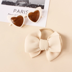 Macro view of baby bow headband with high-elastic nylon band and heart-shaped sunglasses