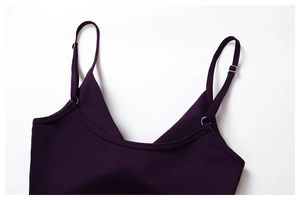 Detail view of purple yoga top with adjustable silver metal buckles on thin shoulder straps